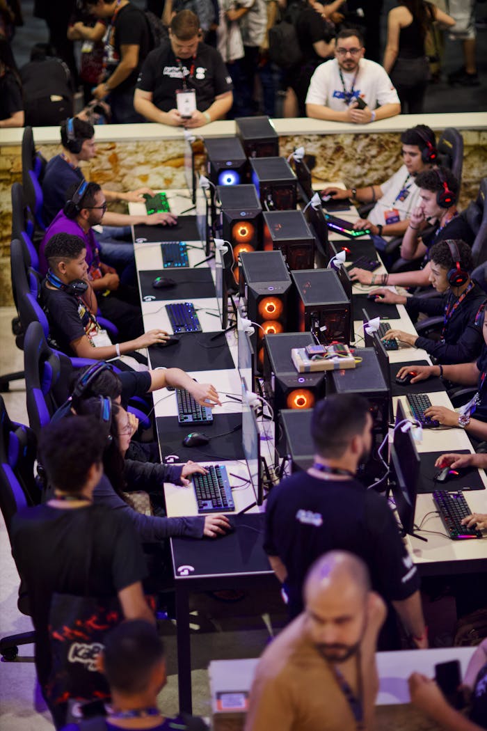 Players engaged in an intense e-sports competition, focused on screens.